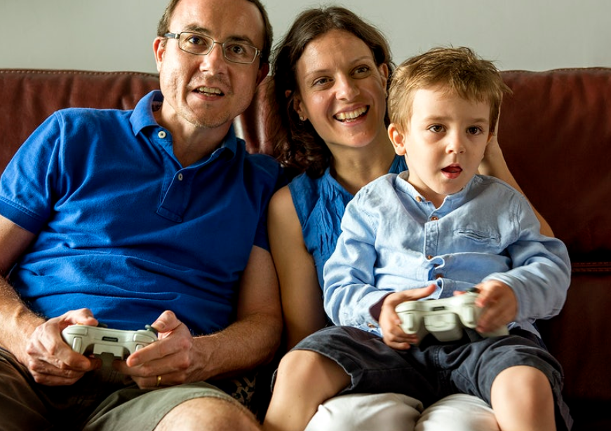 family playing video game with white contoller